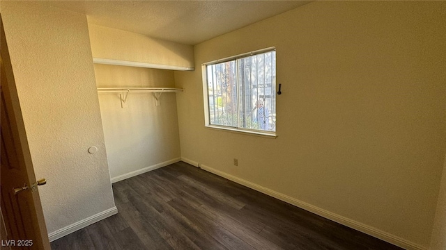3412 Mercury St Unit I, North Las Vegas, NV 89030 - unfurnished bedroom featuring dark wood finished floors and a closet