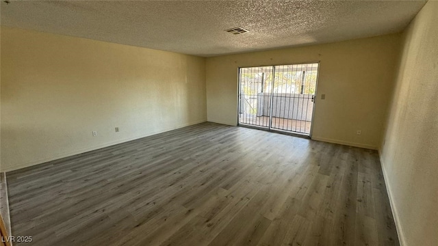 3412 Mercury St Unit I, North Las Vegas, NV 89030 - unfurnished room featuring wood finished floors and a textured ceiling