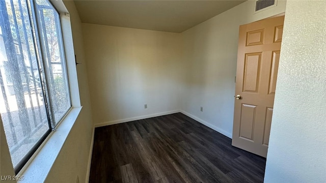 3412 Mercury St Unit I, North Las Vegas, NV 89030 - empty room with plenty of natural light and dark wood finished floors