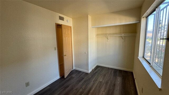 3412 Mercury St Unit I, North Las Vegas, NV 89030 - unfurnished bedroom with dark wood-type flooring and a closet