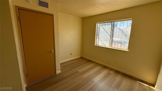 3412 Mercury St Unit I, North Las Vegas, NV 89030 - spare room with wood finished floors and a textured ceiling
