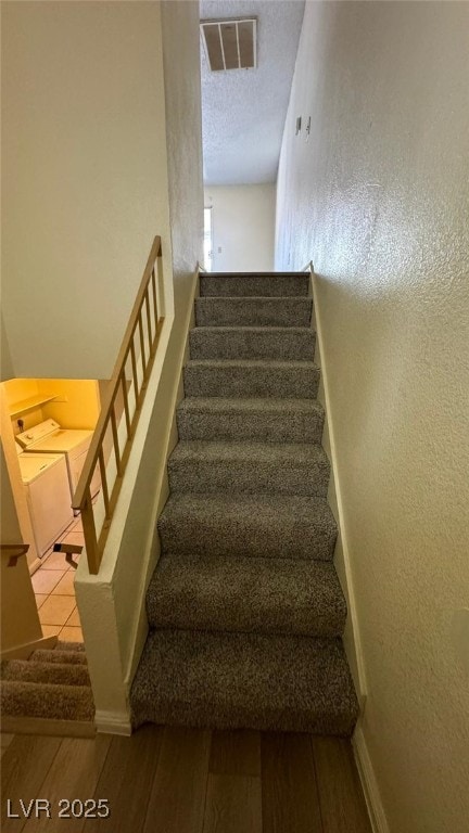 3412 Mercury St Unit I, North Las Vegas, NV 89030 - stairs featuring wood finished floors and a textured ceiling