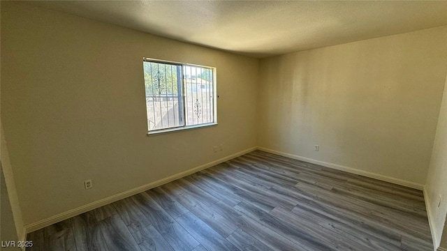 3412 Mercury St Unit I, North Las Vegas, NV 89030 - unfurnished room featuring dark wood finished floors and a textured ceiling