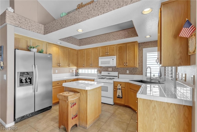 1877 Glory Lily Ct, Las Vegas, NV 89123 - kitchen featuring white appliances, tile countertops, a center island, light tile patterned floors, and a raised ceiling