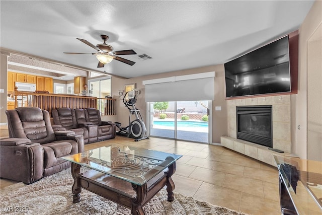 1877 Glory Lily Ct, Las Vegas, NV 89123 - living room featuring a ceiling fan, a tile fireplace, and light tile patterned flooring