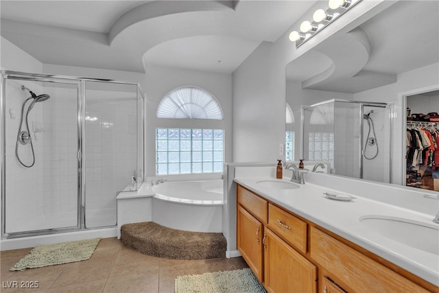 1877 Glory Lily Ct, Las Vegas, NV 89123 - bathroom featuring a shower stall, a bath, double vanity, tile patterned floors, and a spacious closet