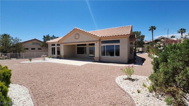 2904 Bow Bridge Dr, Las Vegas, NV 89134 - rear view of property featuring a tiled roof, stucco siding, and a patio area