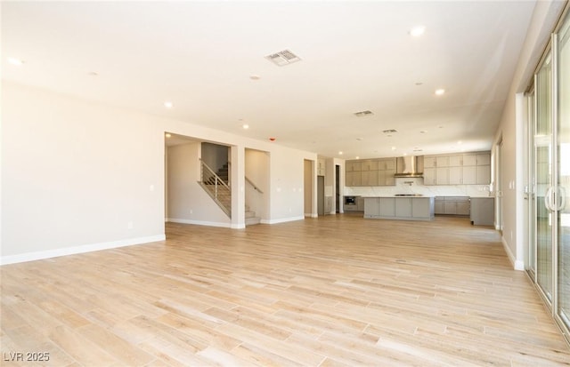 7199 Twilight Rider Ct, Las Vegas, NV 89118 - unfurnished living room featuring light wood-style flooring, stairs, and recessed lighting