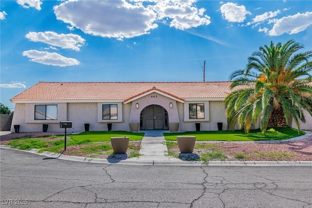 465 E Robindale Rd, Las Vegas, NV 89123 - mediterranean / spanish-style house with a tiled roof, stucco siding, and a front lawn