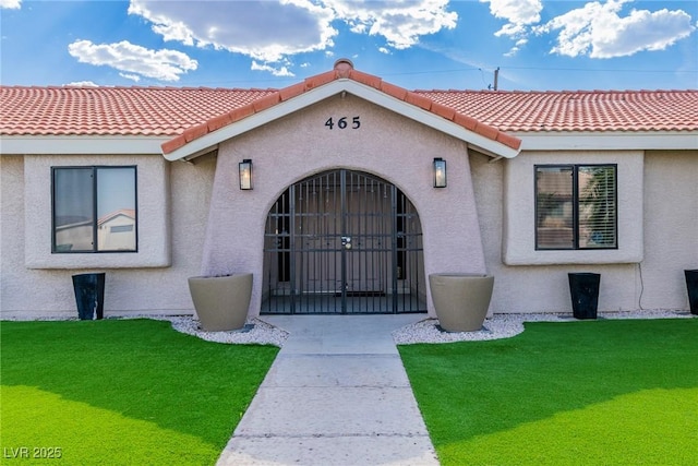 465 E Robindale Rd, Las Vegas, NV 89123 - entrance to property with stucco siding, a tiled roof, and a yard