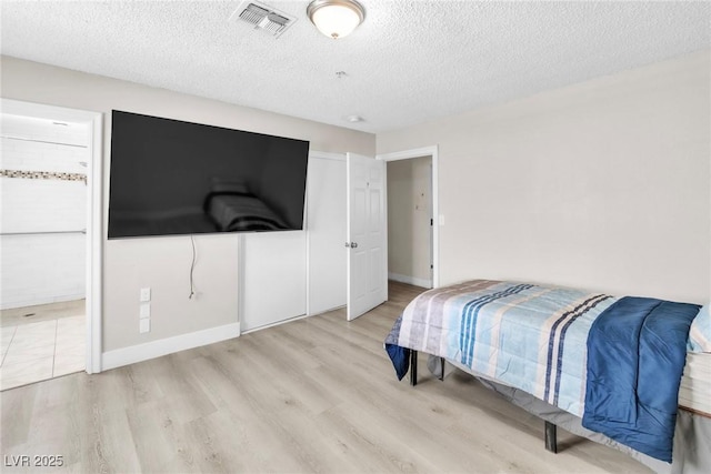 465 E Robindale Rd, Las Vegas, NV 89123 - bedroom featuring wood finished floors, a textured ceiling, and ensuite bathroom