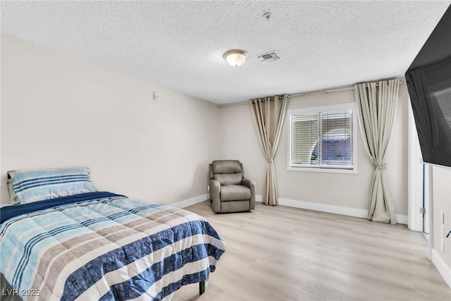 465 E Robindale Rd, Las Vegas, NV 89123 - bedroom with light wood-style floors and a textured ceiling