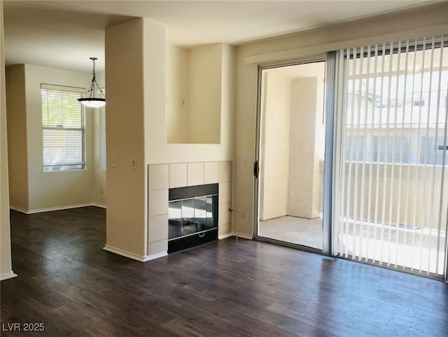 908 Duckhorn Ct Unit 102, Las Vegas, NV 89144 - unfurnished living room with dark wood finished floors and a fireplace