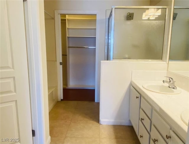 908 Duckhorn Ct Unit 102, Las Vegas, NV 89144 - full bath featuring a stall shower, double vanity, tile patterned floors, and a spacious closet