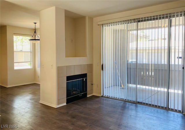908 Duckhorn Ct Unit 102, Las Vegas, NV 89144 - unfurnished living room with dark wood finished floors and a fireplace