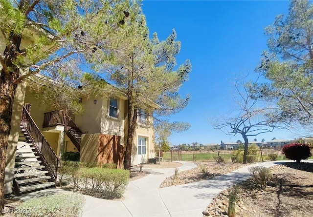 908 Duckhorn Ct Unit 102, Las Vegas, NV 89144 - view of side of home featuring stairs and stucco siding