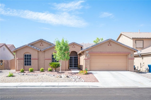 5600 Old Stable Ave, Las Vegas, NV 89131 - mediterranean / spanish home with an attached garage, stucco siding, driveway, and a tiled roof