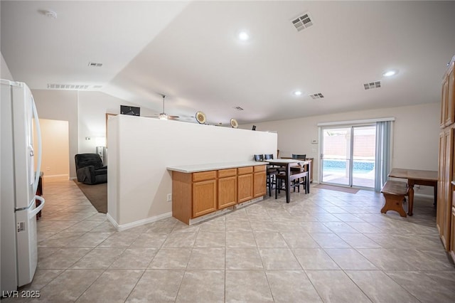5600 Old Stable Ave, Las Vegas, NV 89131 - kitchen featuring freestanding refrigerator, vaulted ceiling, light tile patterned floors, ceiling fan, and recessed lighting