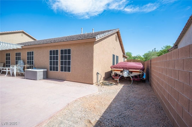 5600 Old Stable Ave, Las Vegas, NV 89131 - rear view of property with stucco siding and a patio area