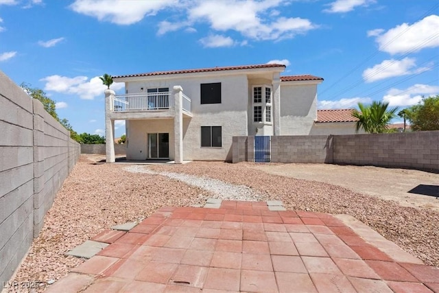 3632 Julia Waldene Ct, Las Vegas, NV 89129 - rear view of house featuring stucco siding, a balcony, a patio area, a fenced backyard, and a tiled roof