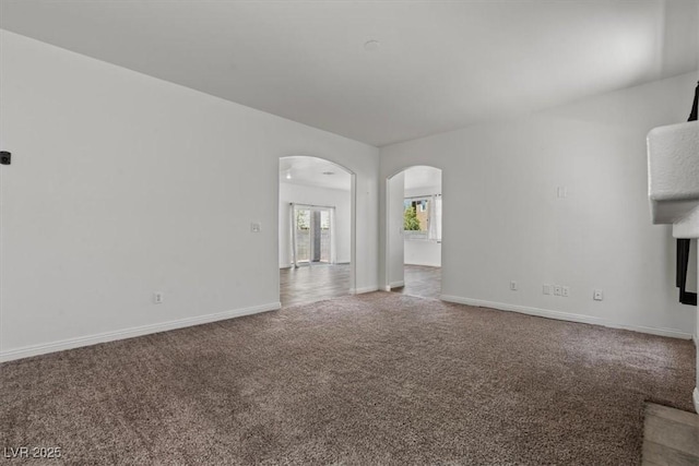 3632 Julia Waldene Ct, Las Vegas, NV 89129 - unfurnished living room featuring arched walkways and carpet floors