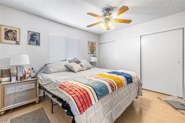 1001 Sulphur Springs Ln Unit 202, Las Vegas, NV 89128 - bedroom with a closet, wood finished floors, ceiling fan, and a textured ceiling