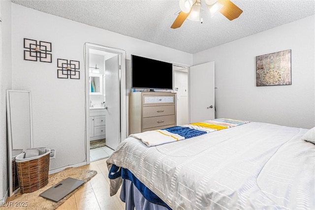 1001 Sulphur Springs Ln Unit 202, Las Vegas, NV 89128 - bedroom with a textured ceiling, ensuite bath, and a ceiling fan