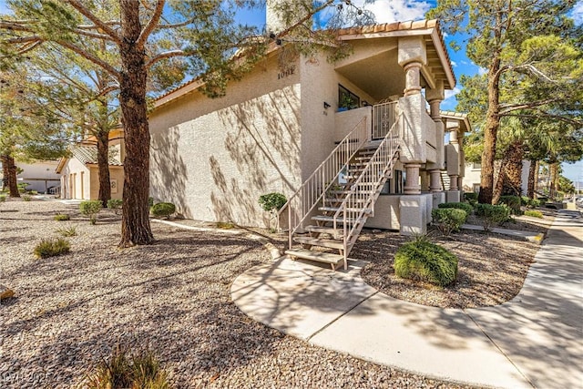 1001 Sulphur Springs Ln Unit 202, Las Vegas, NV 89128 - view of side of home featuring stucco siding and stairway