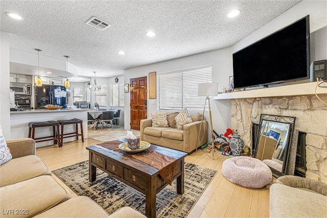 1001 Sulphur Springs Ln Unit 202, Las Vegas, NV 89128 - living area featuring a textured ceiling, light wood finished floors, and recessed lighting