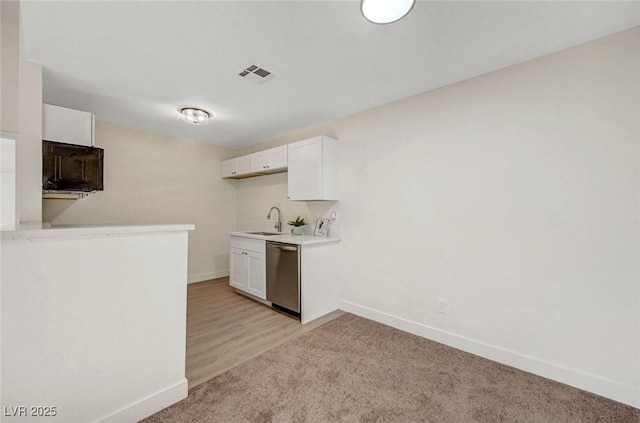 5161 Lindell Rd Unit 206, Las Vegas, NV 89118 - kitchen featuring dishwasher, white cabinets, light countertops, and light carpet