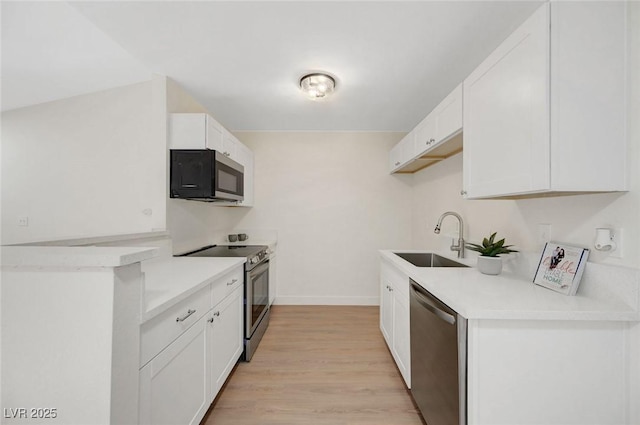 5161 Lindell Rd Unit 206, Las Vegas, NV 89118 - kitchen with appliances with stainless steel finishes, light wood-style flooring, white cabinets, and light countertops