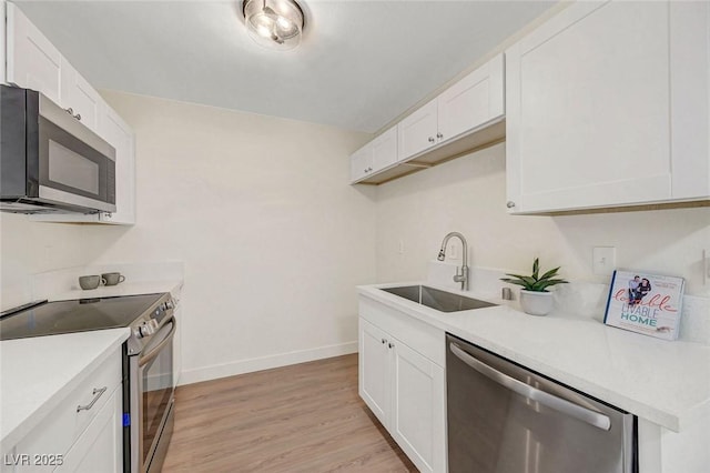 5161 Lindell Rd Unit 206, Las Vegas, NV 89118 - kitchen with appliances with stainless steel finishes, white cabinets, and light countertops