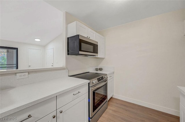 5161 Lindell Rd Unit 206, Las Vegas, NV 89118 - kitchen featuring stainless steel appliances, light countertops, white cabinetry, light wood-style flooring, and recessed lighting