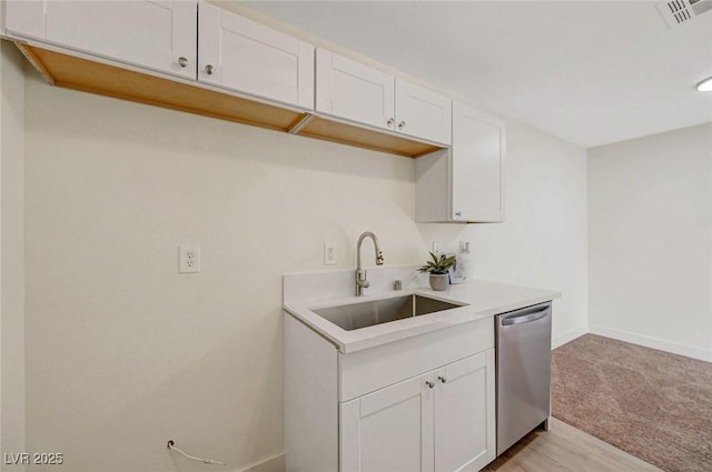 5161 Lindell Rd Unit 206, Las Vegas, NV 89118 - kitchen featuring stainless steel dishwasher, light countertops, white cabinetry, and light carpet