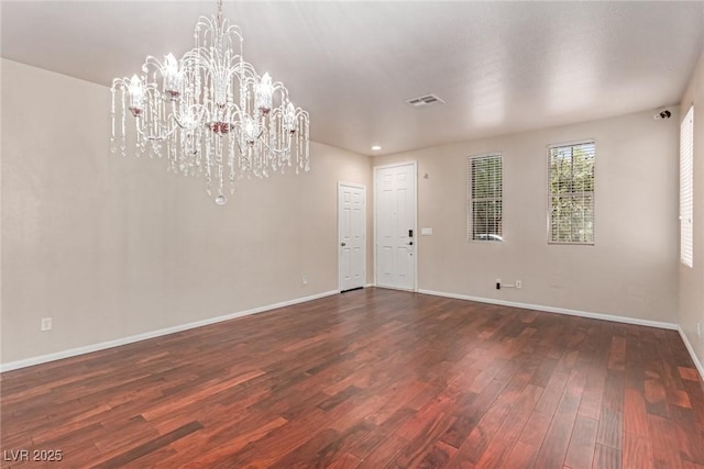 10584 Peach Creek St, Las Vegas, NV 89179 - empty room featuring a chandelier and dark wood-style flooring