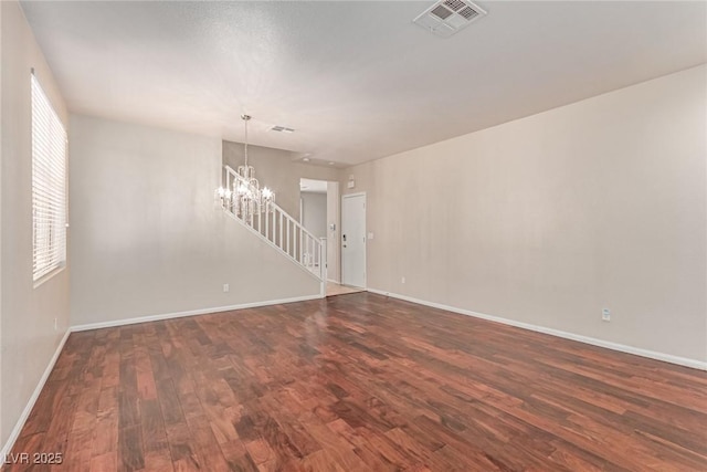 10584 Peach Creek St, Las Vegas, NV 89179 - unfurnished room with dark wood finished floors, a chandelier, and stairway