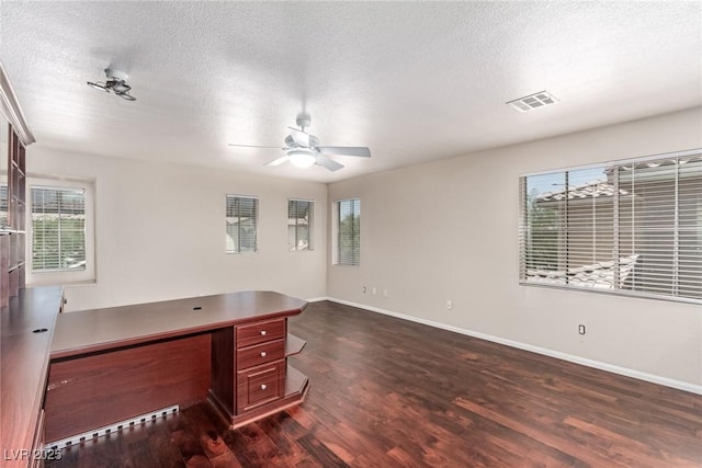 10584 Peach Creek St, Las Vegas, NV 89179 - unfurnished office featuring dark wood-style flooring, plenty of natural light, ceiling fan, and a textured ceiling