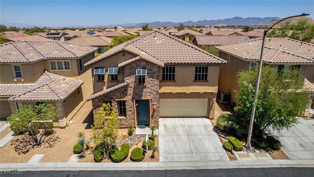 10584 Peach Creek St, Las Vegas, NV 89179 - view of front of home featuring stone siding, stucco siding, driveway, a tiled roof, and a residential view