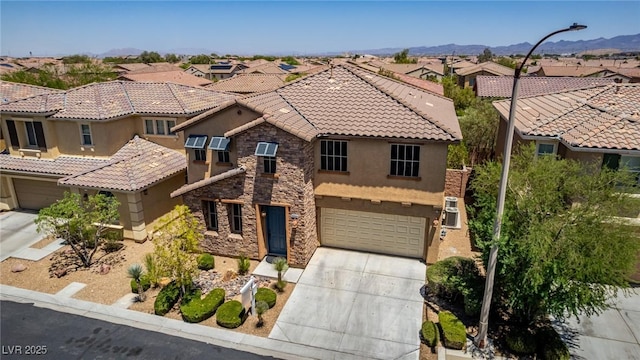 10584 Peach Creek St, Las Vegas, NV 89179 - view of front of house featuring stucco siding, a garage, stone siding, concrete driveway, and a residential view