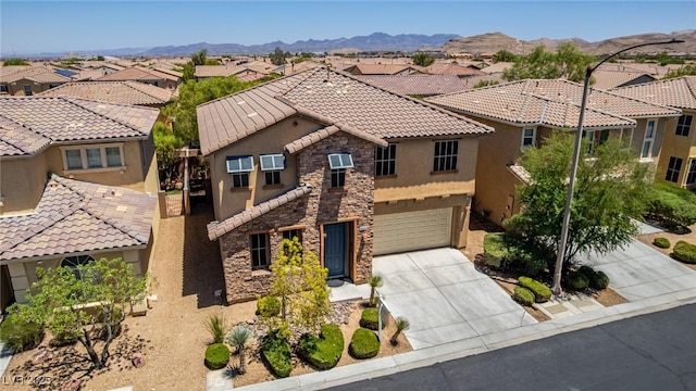 10584 Peach Creek St, Las Vegas, NV 89179 - view of front of home with stone siding, stucco siding, a residential view, a garage, and a tile roof