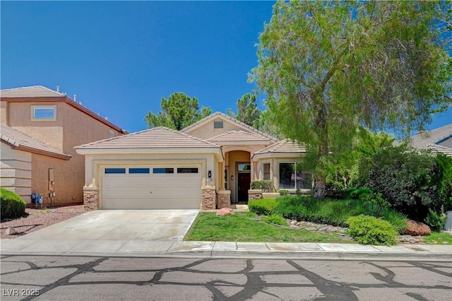 10198 Timber Willow Ave, Las Vegas, NV 89135 - view of front of house featuring an attached garage, concrete driveway, stucco siding, a tiled roof, and stone siding