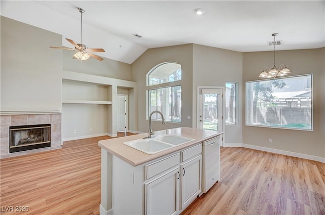 10198 Timber Willow Ave, Las Vegas, NV 89135 - kitchen featuring white dishwasher, light wood finished floors, hanging light fixtures, ceiling fan, and high vaulted ceiling