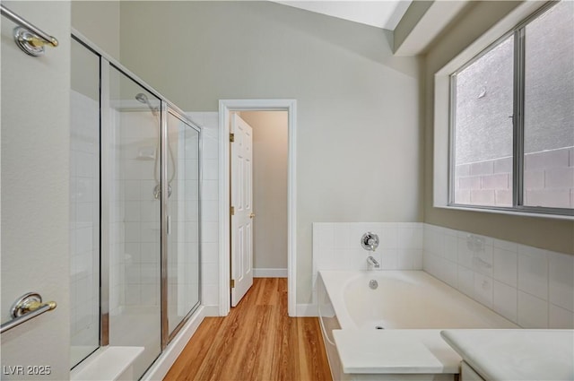 10198 Timber Willow Ave, Las Vegas, NV 89135 - bathroom with a shower stall, a garden tub, and wood finished floors