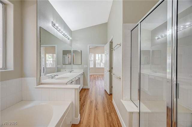 10198 Timber Willow Ave, Las Vegas, NV 89135 - bathroom with wood finished floors, double vanity, a bath, and plenty of natural light