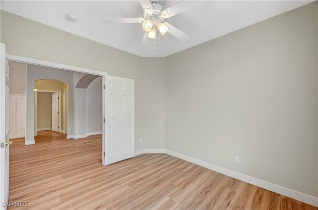 10198 Timber Willow Ave, Las Vegas, NV 89135 - spare room with arched walkways, light wood-style floors, a ceiling fan, and a smoke detector
