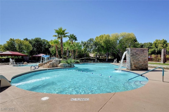 10198 Timber Willow Ave, Las Vegas, NV 89135 - community pool featuring a patio area and view of scattered trees