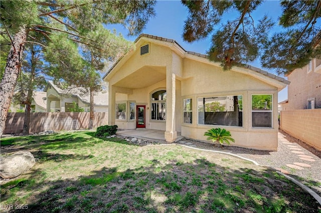 10198 Timber Willow Ave, Las Vegas, NV 89135 - rear view of property featuring stucco siding, a fenced backyard, and a patio