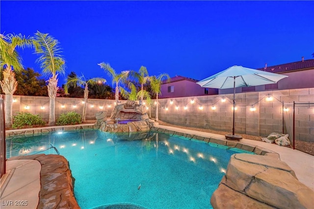 1717 Jake Andrew Ave, North Las Vegas, NV 89086 - pool at twilight featuring a fenced backyard and a pool with connected hot tub