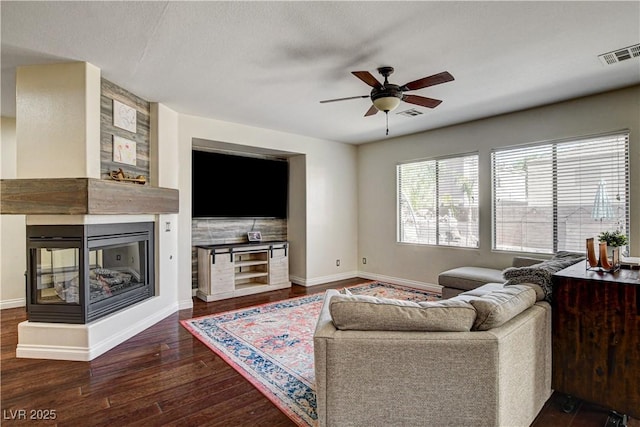 1717 Jake Andrew Ave, North Las Vegas, NV 89086 - living area with wood finished floors, ceiling fan, and a multi sided fireplace