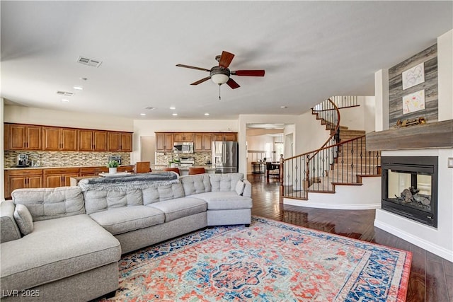 1717 Jake Andrew Ave, North Las Vegas, NV 89086 - living area with ceiling fan, stairway, dark wood-style flooring, a multi sided fireplace, and recessed lighting